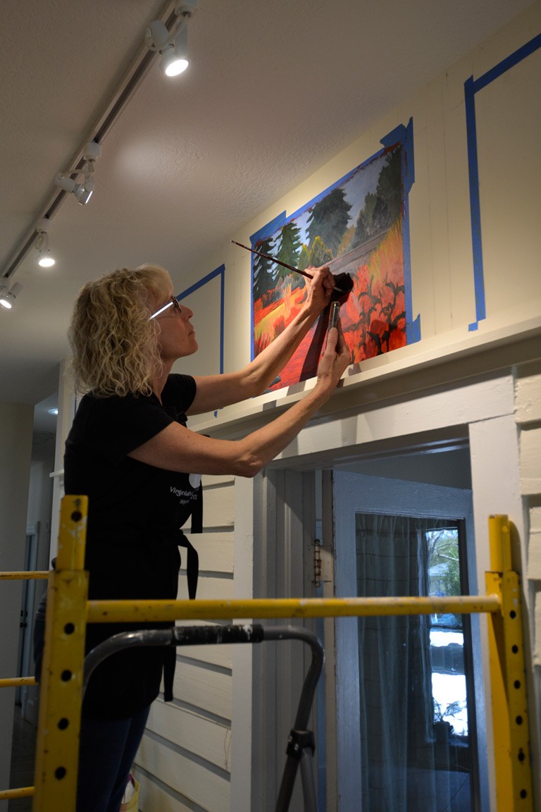 Michele Walter at work on the Shelter Alternatives mural